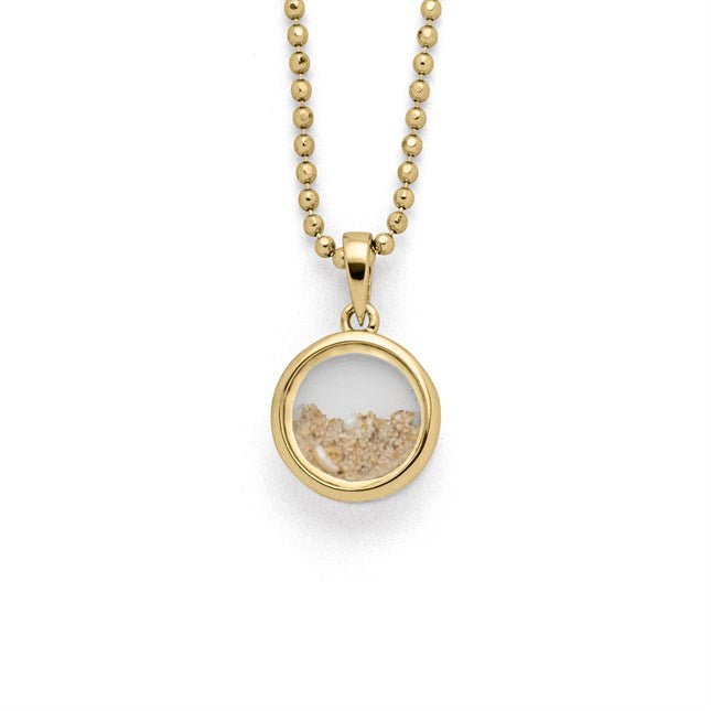 runder Anhänger "Sandsturm" mit Strandsand und Muschelstückchen, gefasst in vergoldetem 925er Sterlingsilber.